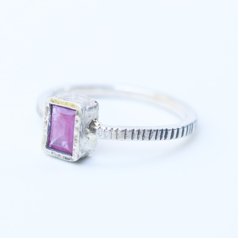 Pink sapphire in silver bezel setting with oxidized sterling silver texture design band