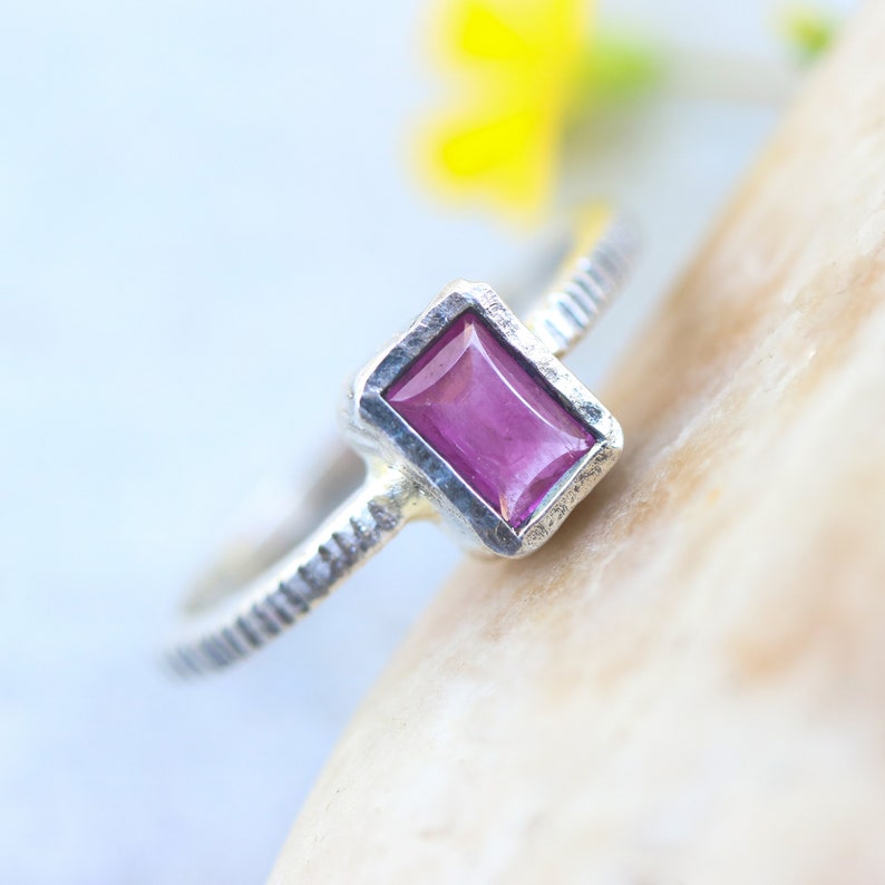 Pink sapphire in silver bezel setting with oxidized sterling silver texture design band