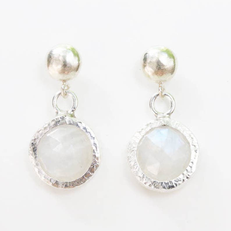 Round faceted moonstone in silver texture bezel setting with post style