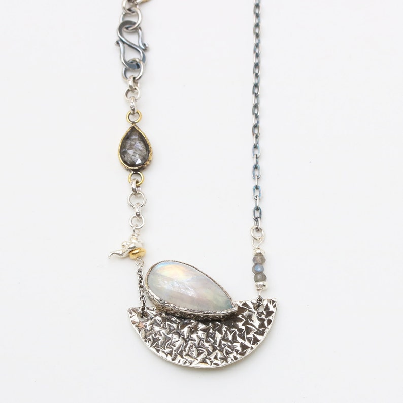 Moonstone pendant necklace in silver bezel setting and silver textured fan with black rutilated quartz on the side and oxidized silver chain