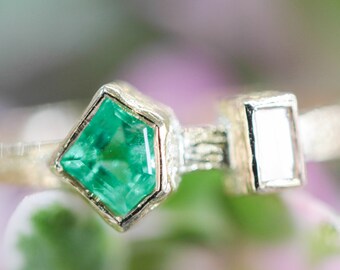 Emerald ring and diamond on the side with 18k gold texture band