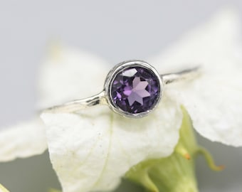 Round faceted amethyst ring in silver bezel setting with sterling silver band