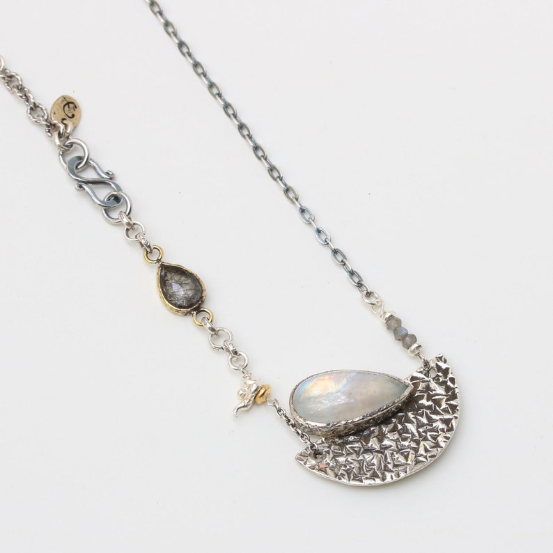 Moonstone pendant necklace in silver bezel setting and silver textured fan with black rutilated quartz on the side and oxidized silver chain