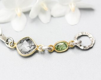 Black rutilated quartz pendant bracelet with green sapphire gemstone on sterling silver chain