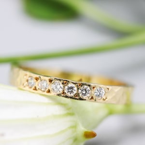 Tiny diamond eternity ring with 18k yellow gold band