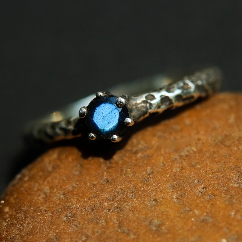 Round faceted labradorite ring in prongs setting with sterling silver oxidized texture band