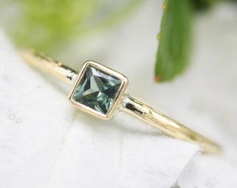 Princess cut multi green sapphire ring in bezel setting with 18k gold texture band