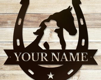 May include: Black metal horseshoe with a horse and foal silhouette inside. A banner below reads "YOUR NAME".