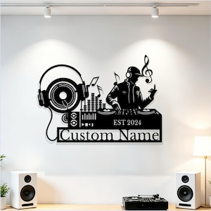 May include: A black wall-mounted metal sign featuring a DJ silhouette, headphones, a mixing console, and musical notes. The design includes the text EST 2024 and a placeholder for Custom Name, showcasing a detailed graphic of music equipment.