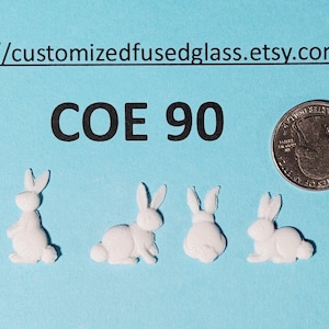 May include: Four small, white bunny figurines in various poses are displayed on a light blue background, next to a US quarter coin. The text "COE 90" is above the bunnies. The Etsy shop URL is at the top.