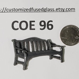 May include: A miniature dark gray bench with detailed armrests and back slats. A US quarter coin is next to the bench for size comparison. The text "COE 96" is above the bench.