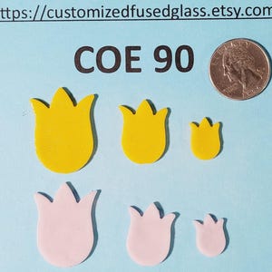 May include: Yellow and pink tulip-shaped glass pieces in three sizes, with a quarter for scale. The text "COE 90" is above the glass shapes. The Etsy shop URL is at the top of the image.