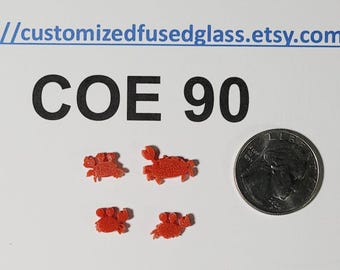 May include: Four small, orange, glittery crab-shaped glass pieces arranged near a US quarter coin. The text "//customizedfusedglass.etsy.com" and "COE 90" are printed in black and blue above the items, providing a scale reference for the glass.