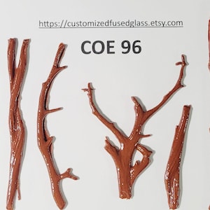 May include: Several brown glass branch shapes are arranged on a white background. The branches vary in size and shape, some with multiple offshoots. The text "COE 96" is visible, along with a website address.