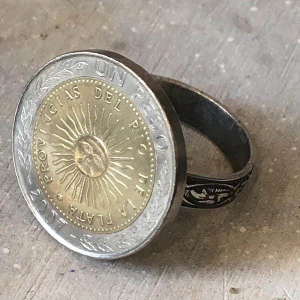 COIN JEWELRY   Genuine coin from ARGENTINA crafted into a ring.  This adjustable ring has beautiful tooling on the band.