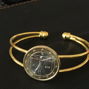 Bangle cuff adjustable bracelet made with a genuine Italian euro coin. Featuring the Vitruvian man