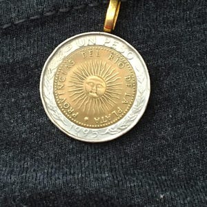 COIN JEWELRY  The Sun coin from ARGENTINA crafted into an attractive pendant.