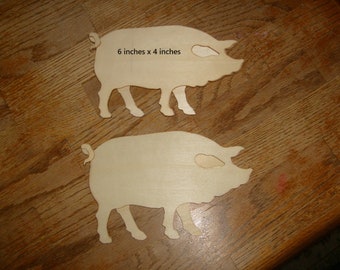 Two unfinished wood pigs