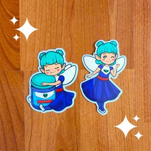 May include: Two blue and green fairy stickers with wings. One fairy is holding a blue jar with a green lid. The other fairy is waving.