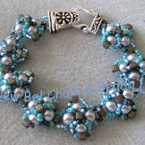 May include: A silver bracelet with a clasp and a design of blue and silver beads.