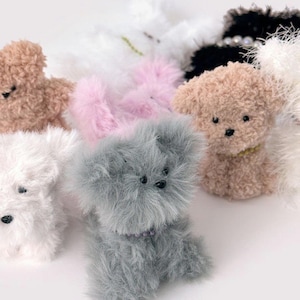 May include: A collection of plush toy animals in various colors and styles, including a white dog, a gray dog, a pink dog, a brown dog, and a white bear.