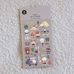 May include: A sheet of Daily Deco Stickers with a camping theme. The stickers feature cartoon dogs, tents, campfires, and other camping-related illustrations. The text "Daily Deco Stickers" and "Let's go camping" are visible.