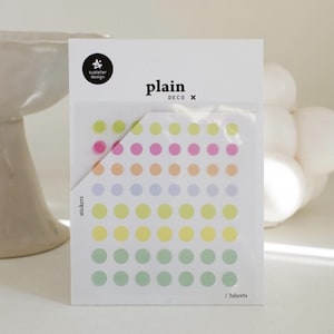 May include: A pack of colorful dot stickers with a gradient of colors from pink to green. The pack includes 3 sheets of stickers and is labeled "plain x DECO stickers".