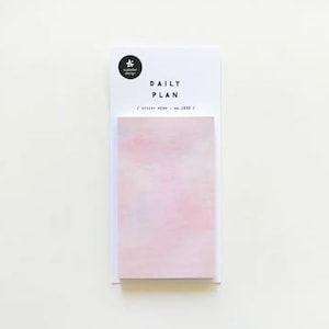 May include: A pink sticky note pad with the text "DAILY PLAN / STICKY MEMO / NO.1930 /" printed on the front.
