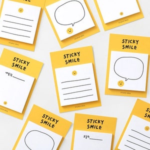 May include: Yellow sticky notes with the text "STICKY SMILE" and a simple smiley face design. Some notes have lined paper, while others have a blank space for writing and a speech bubble.