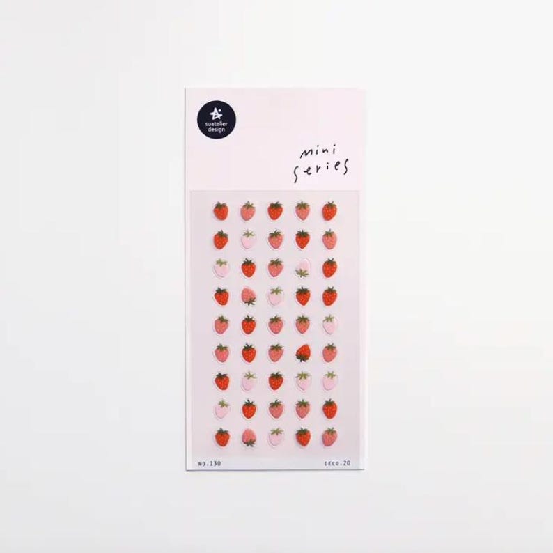May include: A sheet of strawberry stickers in various shades of red and pink. The stickers are arranged in rows and columns on a white background. The text "mini series" is printed on the top right corner.