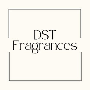 May include: The image features the text "DST Fragrances" in a stylish, elegant font. The text is centered within a black rectangular frame against a cream-colored background. The overall design is minimalist and sophisticated.