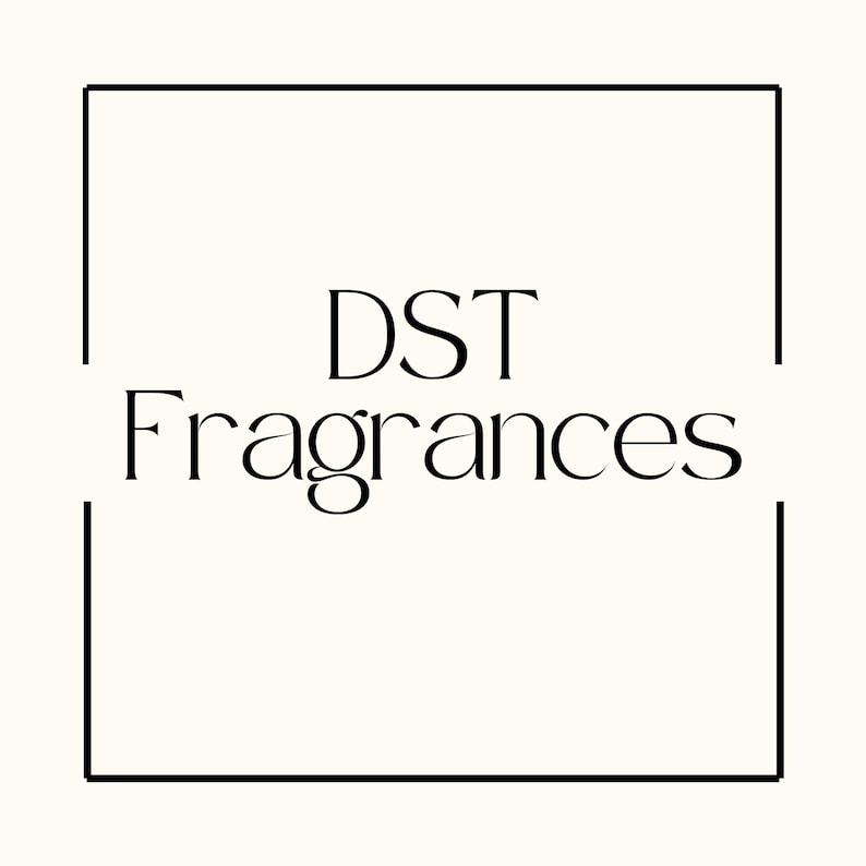 May include: The image features the text "DST Fragrances" in a stylish, elegant font. The text is centered within a black rectangular frame against a cream-colored background. The overall design is minimalist and sophisticated.