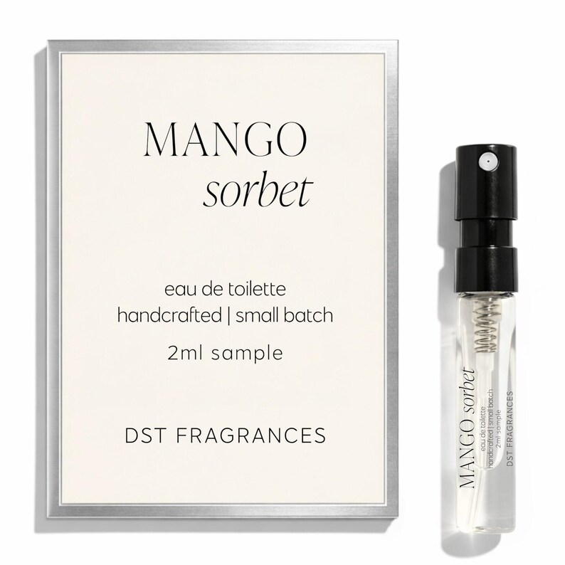 May include: A 2ml sample of Mango Sorbet eau de toilette by DST Fragrances, presented in a clear glass spray vial with a black cap, alongside a rectangular card featuring the product name, description, and brand name in black text.