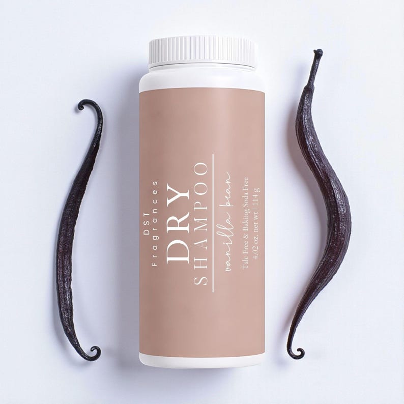 May include: A white bottle of DST Fragrances dry shampoo with a tan label and a white cap. The label reads "DRY SHAMPOO vanilla bean". Two dark brown vanilla beans flank the bottle. The bottle contains 4.02 oz. net wt 114 g.