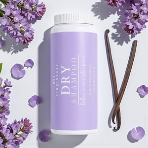 May include: A white and purple dry shampoo bottle with the text "DRY SHAMPOO" and "lilac + vanilla bean". The bottle is surrounded by purple flowers and two vanilla beans. The bottle contains 4.02 oz. net wt.