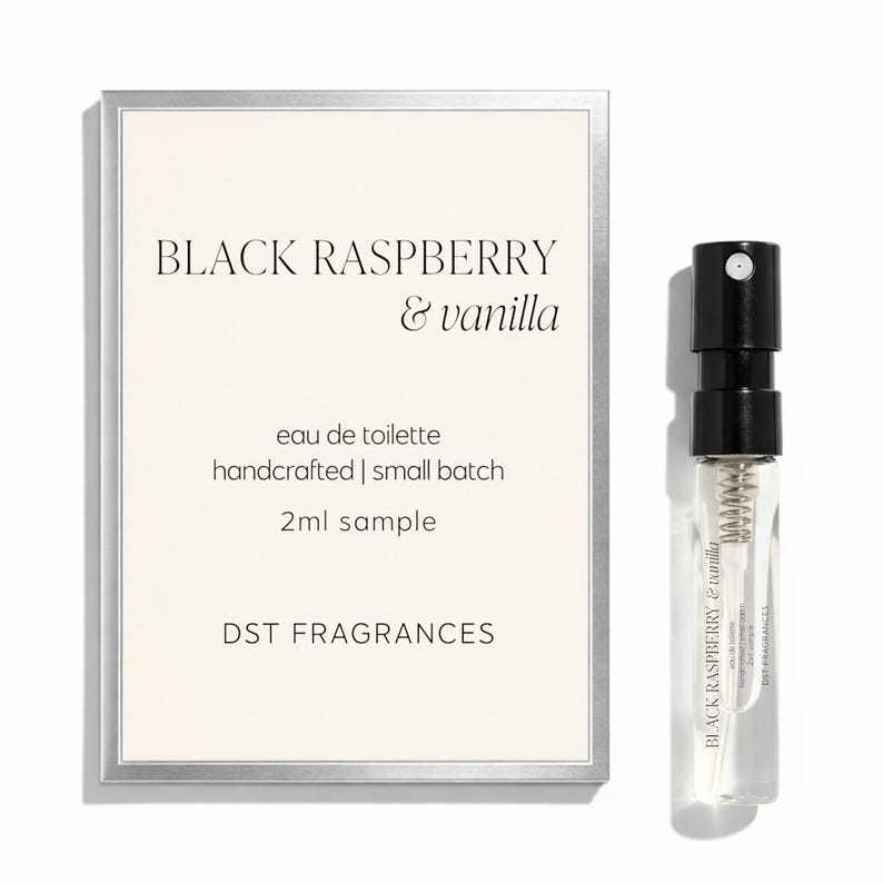 May include: A 2ml sample spray vial of Black Raspberry & vanilla eau de toilette by DST FRAGRANCES, accompanied by a rectangular product card with a silver border featuring the scent name, product details, and brand name in black text.
