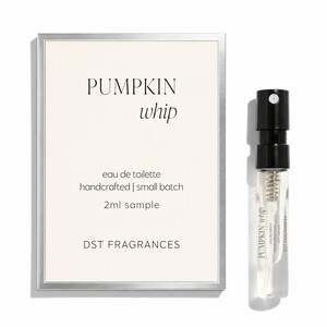 May include: A rectangular card with a silver border featuring the text PUMPKIN whip, eau de toilette, handcrafted | small batch, 2ml sample, and DST FRAGRANCES, alongside a clear glass 2ml spray vial with a black cap and a label reading PUMPKIN whip.
