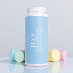 May include: A cylindrical dry shampoo bottle with a white cap and a light blue label. The label reads "DRY SHAMPOO" and "sugared marshmallow". Several pastel-colored marshmallow-shaped objects are in front of the bottle. The bottle contains 4.02 oz.