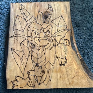 Spyro the dragon wood burning on live edge