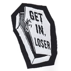 May include: Black and white embroidered patch of a coffin with the text "GET IN, LOSER" on the front.