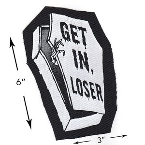 May include: Black and white embroidered patch shaped like a coffin with the text "GET IN, LOSER" on the front. The patch is 6 inches tall and 3 inches wide.