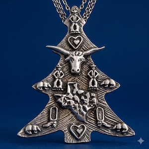 May include: Silver-toned pendant necklace in the shape of a Christmas tree. The pendant features a longhorn, cowboy figures, bears, hearts, the state of Texas, and cowboy boots. The necklace hangs on a silver chain.