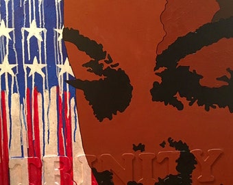 Pode incluir: Uma pintura de um rosto com um esquema de cores vermelho, marrom e preto. O rosto está parcialmente obscurecido por uma bandeira americana vermelha, branca e azul com estrelas brancas. A palavra "UNITY" está escrita em letras brancas na parte inferior da pintura.