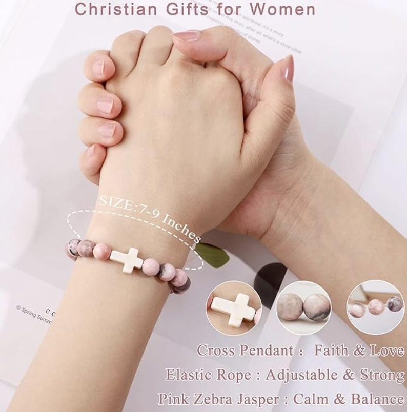 May include: A pink and white beaded bracelet with a white cross charm. The bracelet is made with elastic rope and pink zebra jasper beads. The bracelet is 7-9 inches in size.