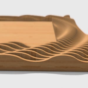 May include: A wooden tray with a decorative wave pattern around the edge. The tray is made of light brown wood and has a smooth surface.