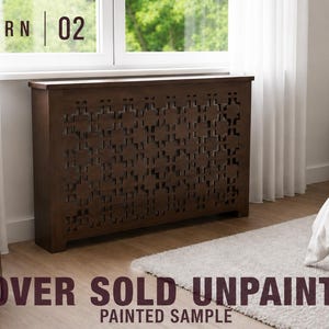 May include: A dark brown wooden radiator cover featuring a geometric cutout pattern. The text PATTERN 02 is visible in the top left corner, and the text COVER SOLD UNPAINTED PAINTED SAMPLE is visible at the bottom of the image.