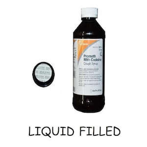 May include: A dark brown cough syrup bottle with a white cap and a detached black cap. The label reads "Prometh With Codeine Cough Syrup." The text "LIQUID FILLED" is at the bottom.