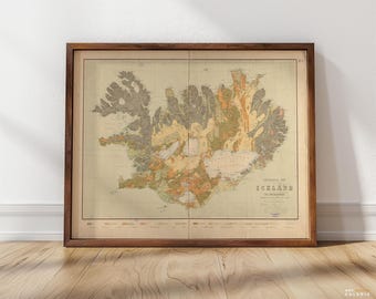 May include: A vintage map of Iceland in a brown wooden frame. The map is printed on cream paper and shows the island's geological features in various shades of brown, green, and yellow. The title "Geological Map of ICELAND" is printed in the bottom right corner.