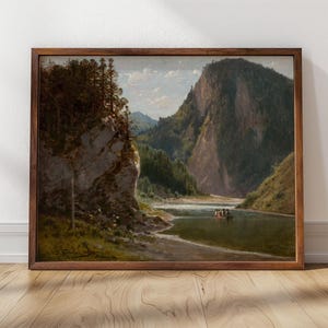 May include: A painting depicting a river scene with a mountain range in the background. The river is in the foreground and there are trees and rocks on the banks. The sky is blue and there are clouds in the distance.
