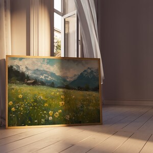 May include: A framed landscape painting depicting a field of wildflowers with a small house in the distance and snow-capped mountains in the background.